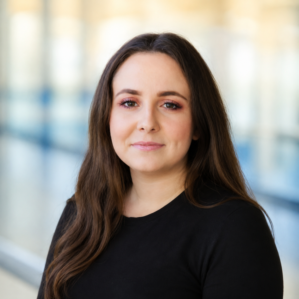 Woman with long brown hair wearing a black shirt